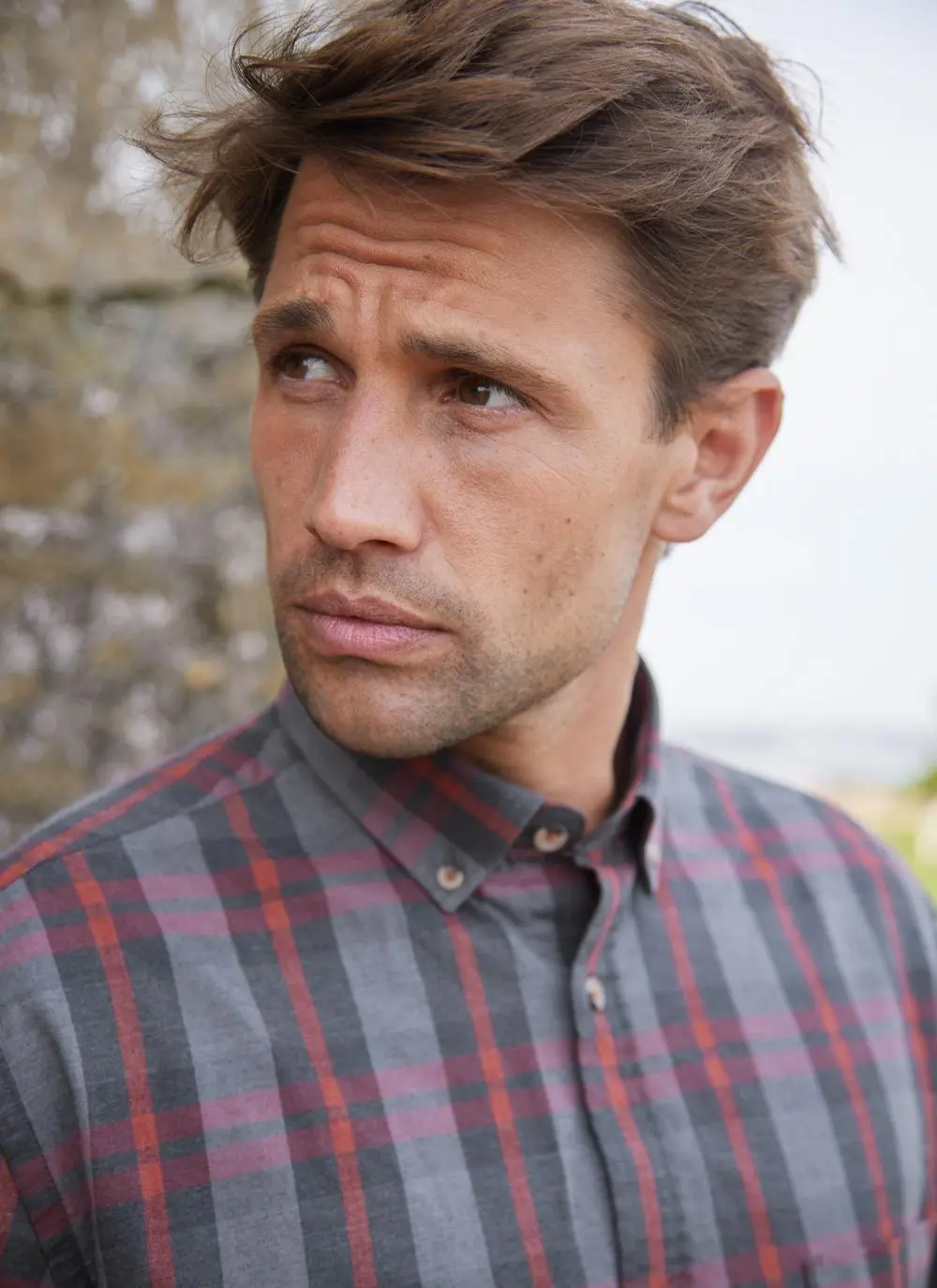 Man wearing a check shirt, close up