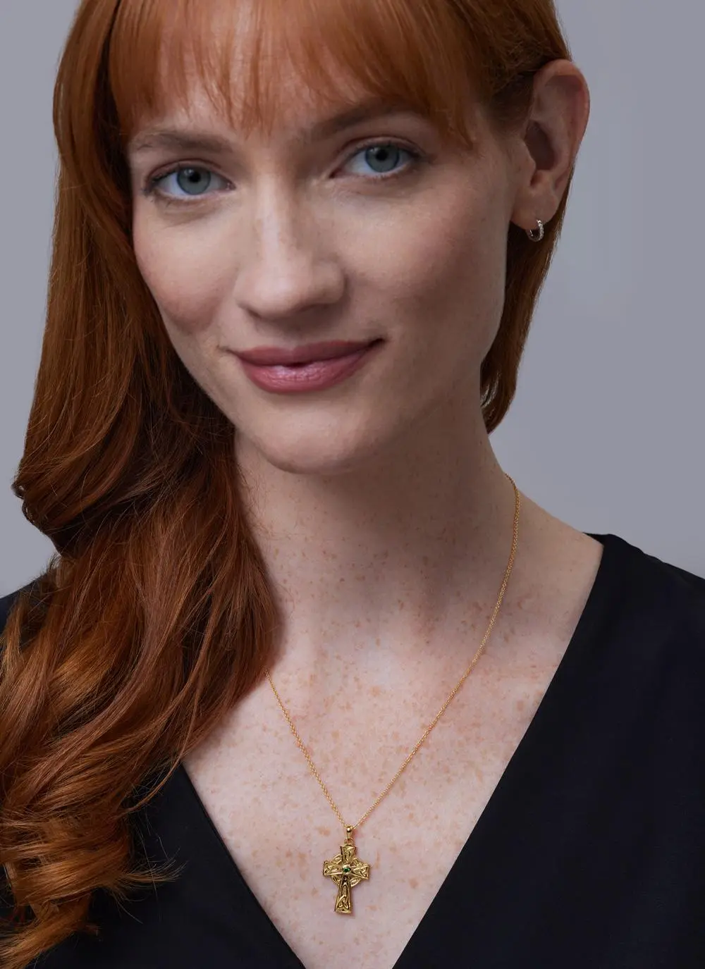 Red haired model wearing Celtic Cross Pendant with Green Cubic Zirconia