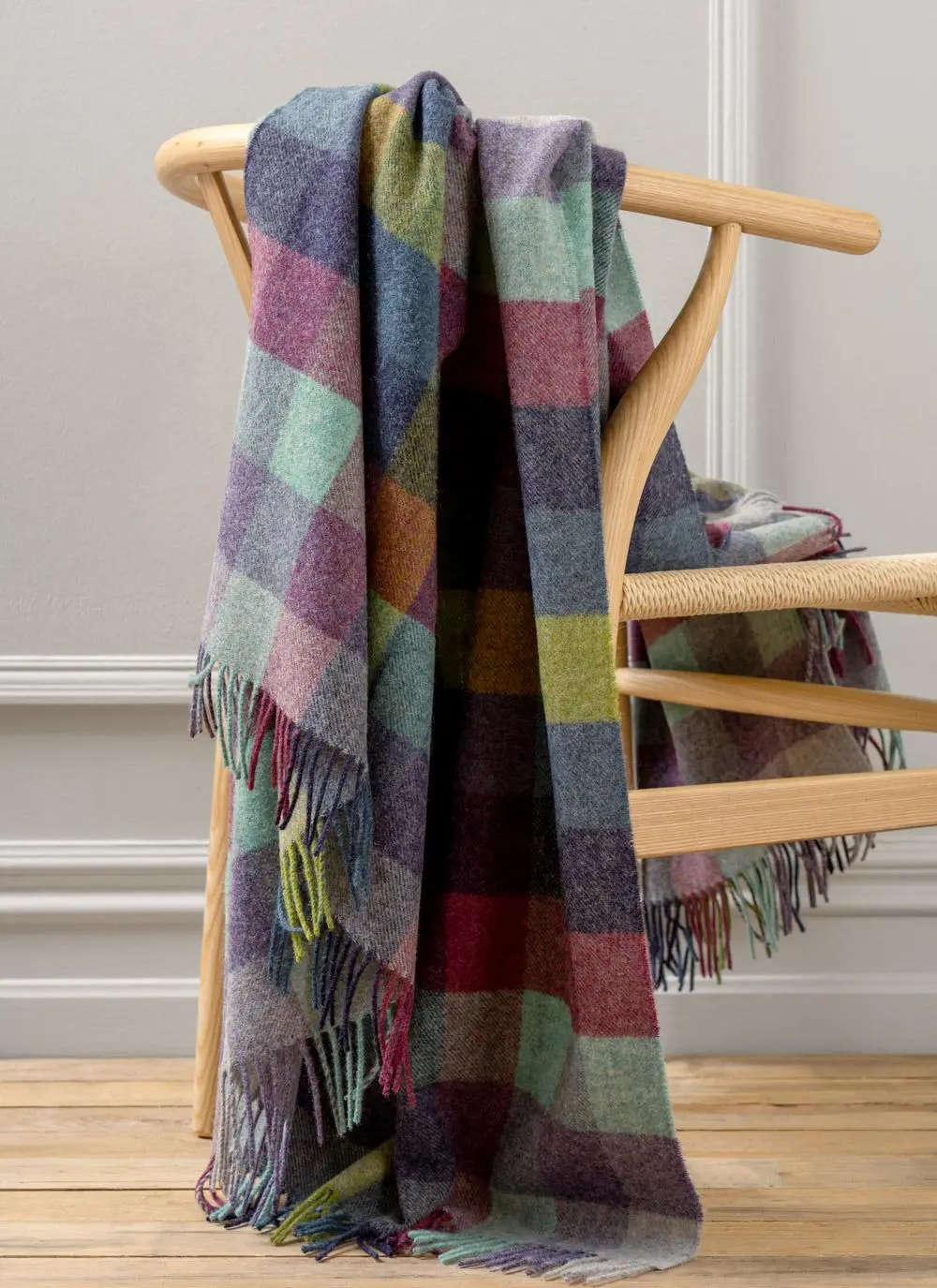 Blue and purple check highland wool throw draped across wooden chair