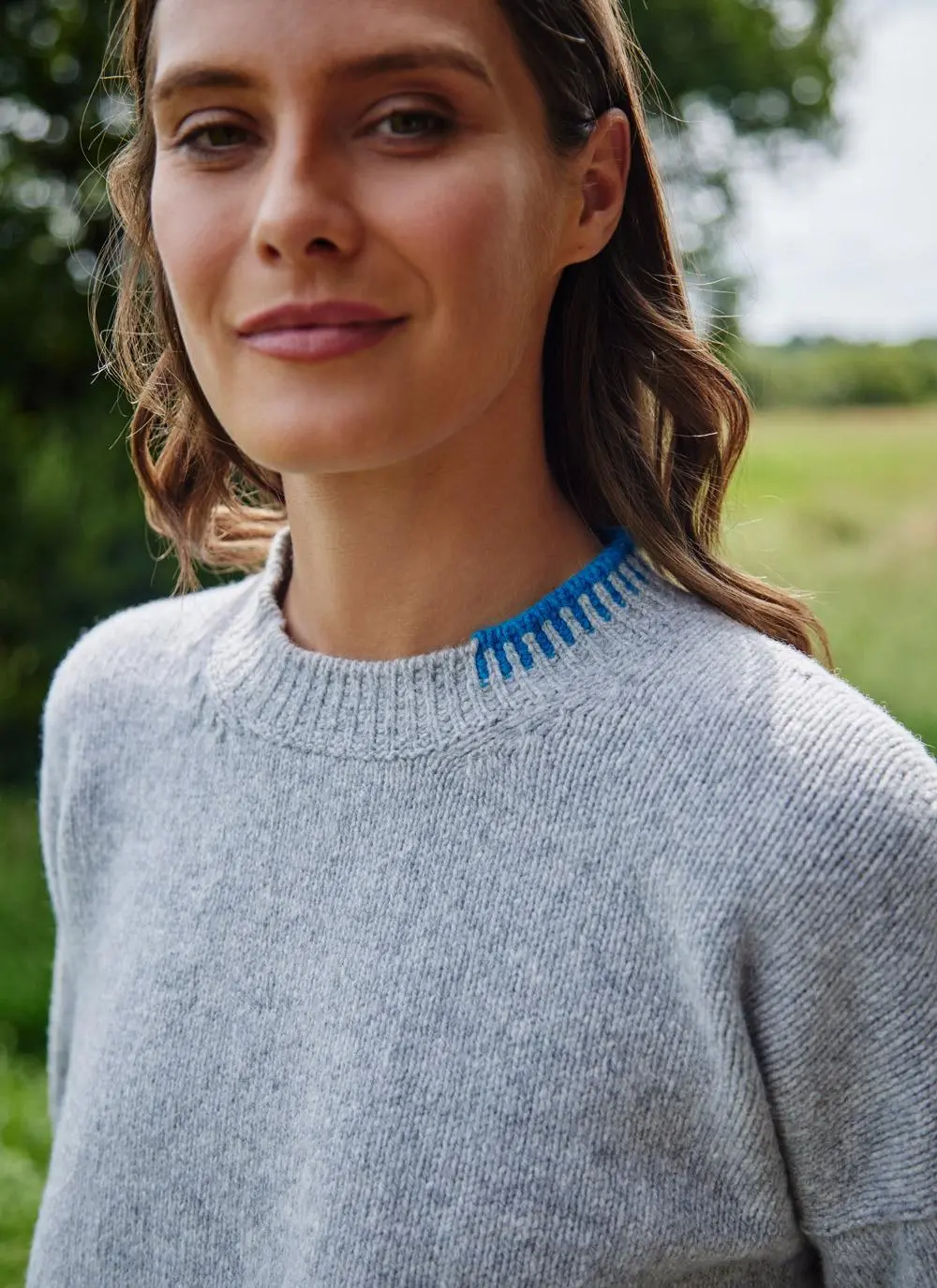 close up of woman wearing grey sweater 