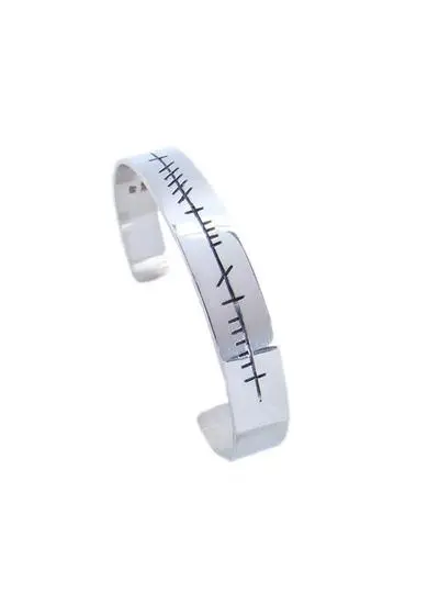 White background cut out shot of Sterling Silver Ogham Love Forever Bangle